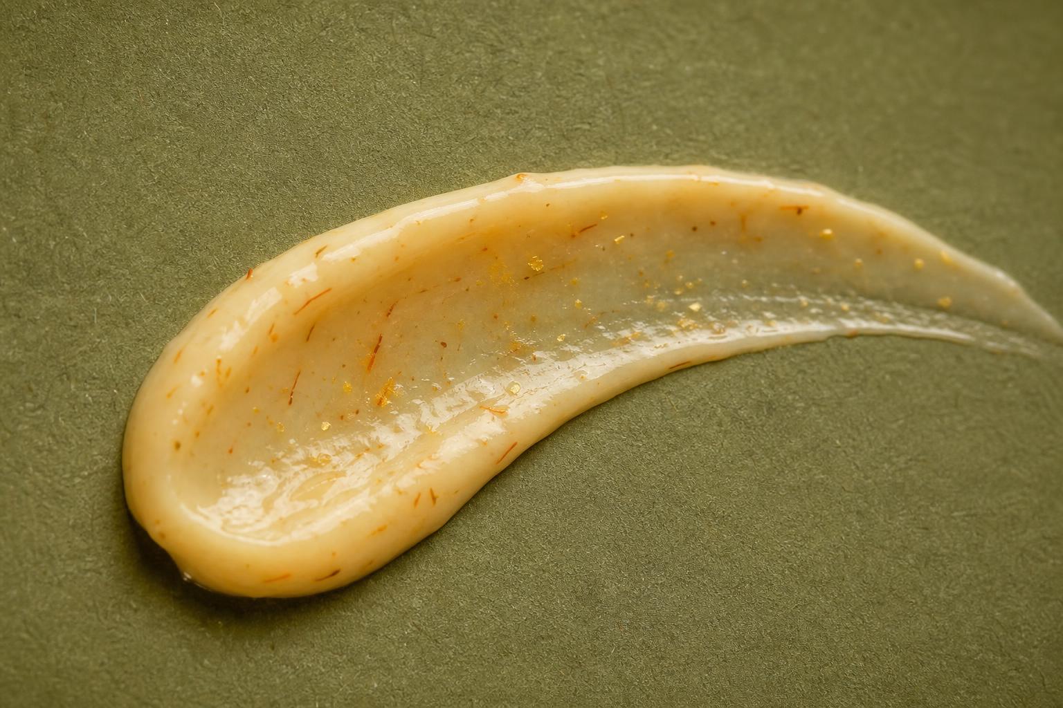 Macro texture of a botanical ATAEI cream with saffron flecks